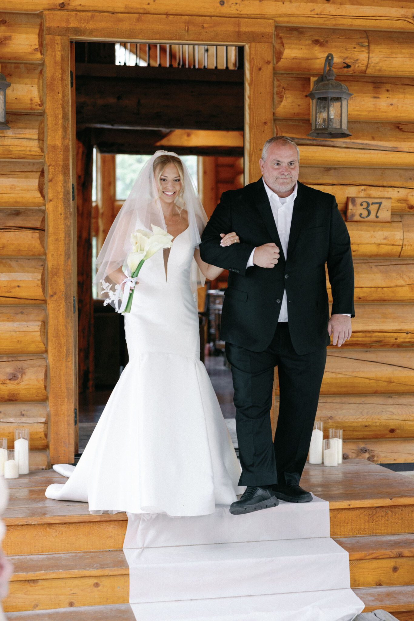 bride walks down the aisle with her father