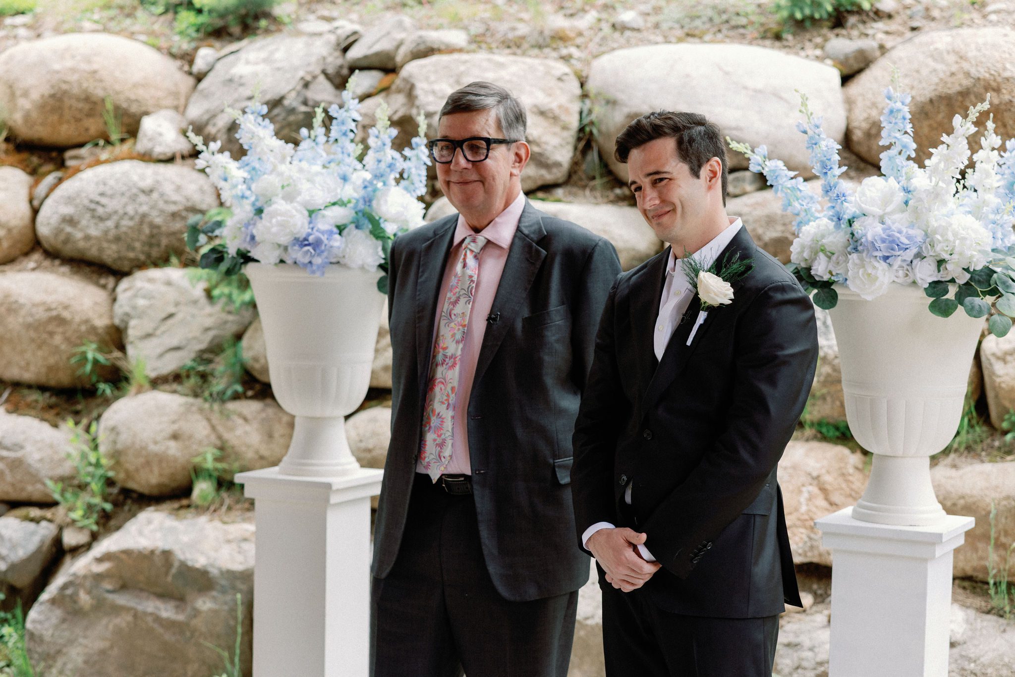 groom smiles and tears up as he sees his bride for the first time