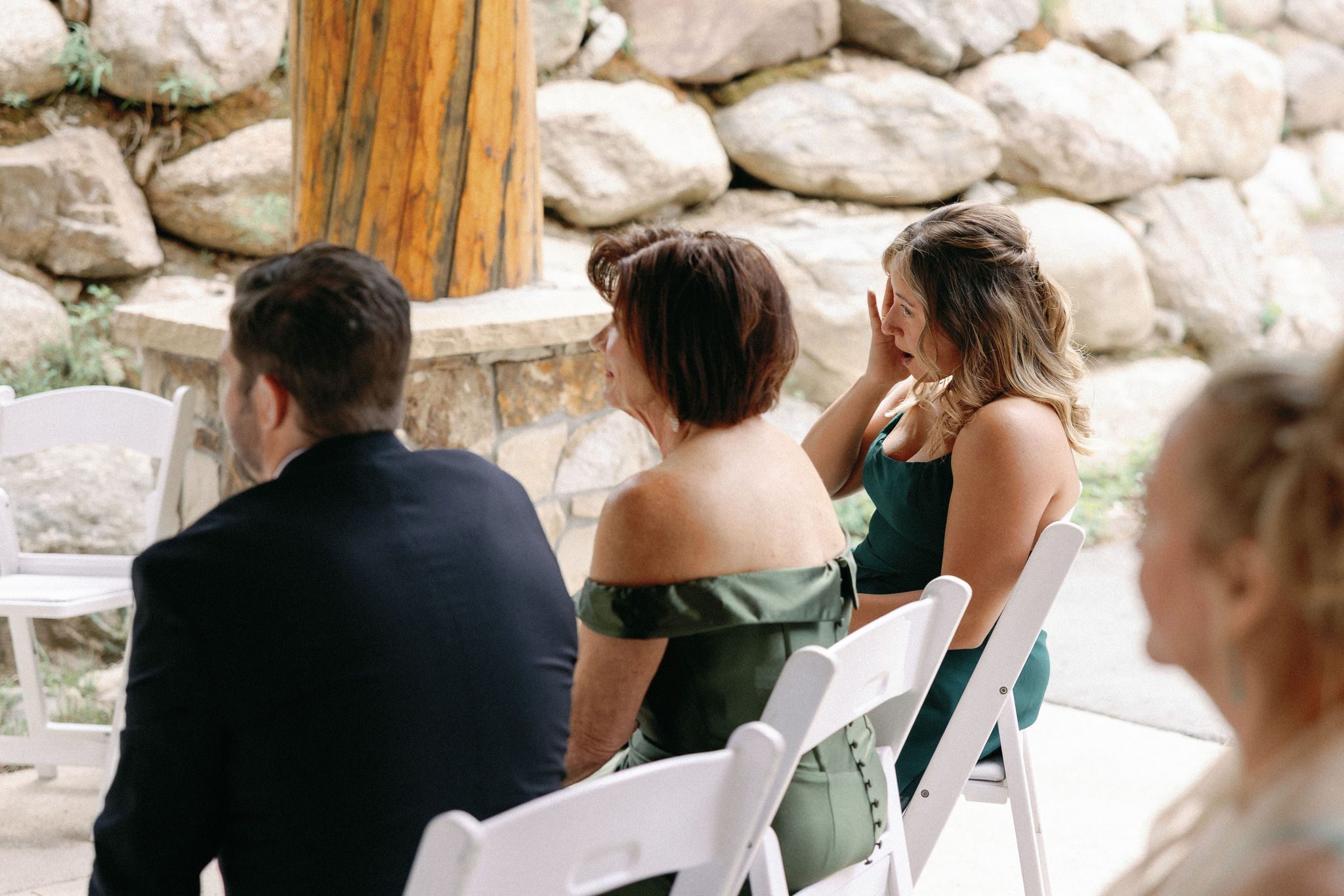 grooms family wipes away tears during the wedding ceremony
