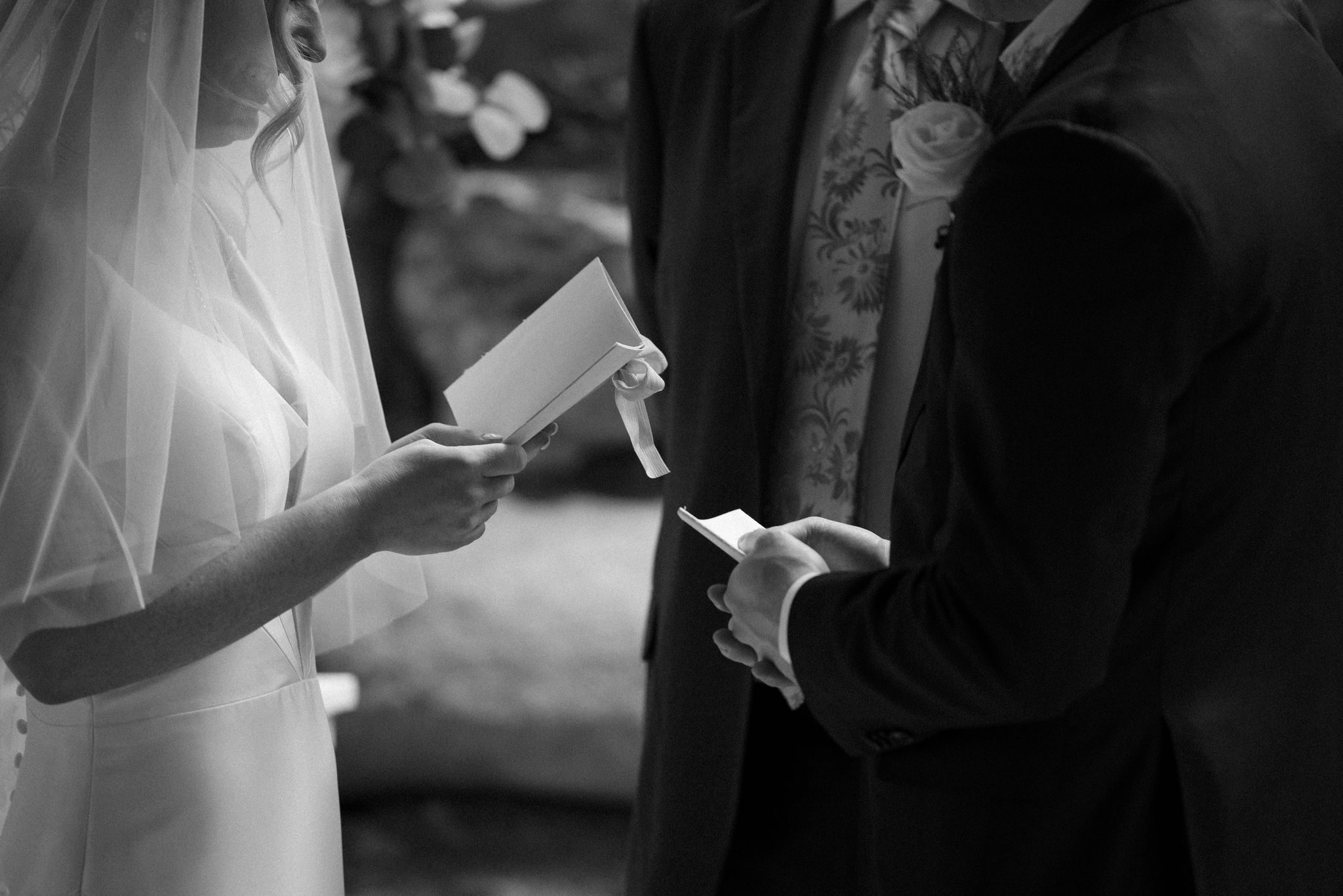 close up image of bride and groom holding their wedding vow books