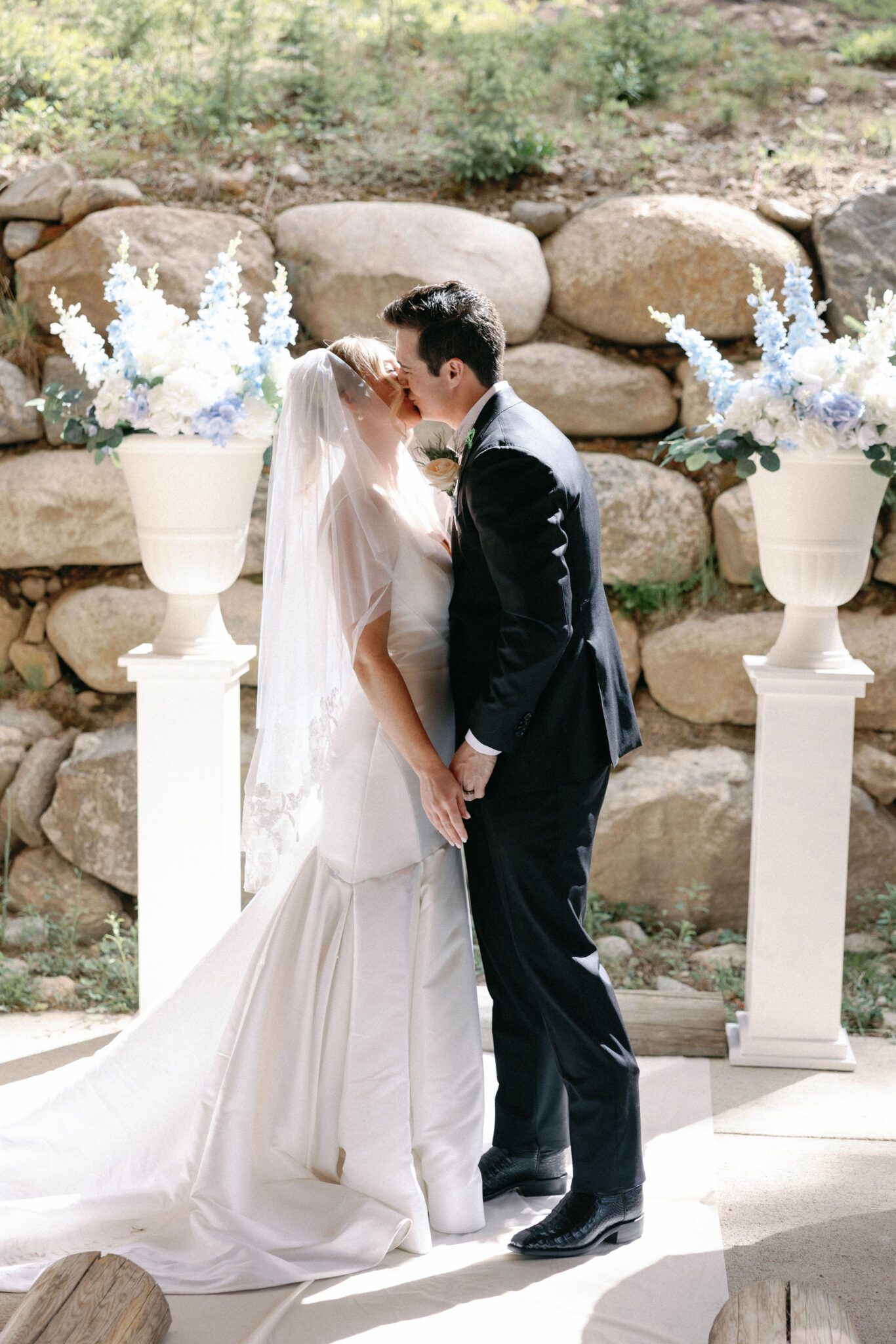 bride and groom share their first kiss as husband and wife during the wedding ceremony