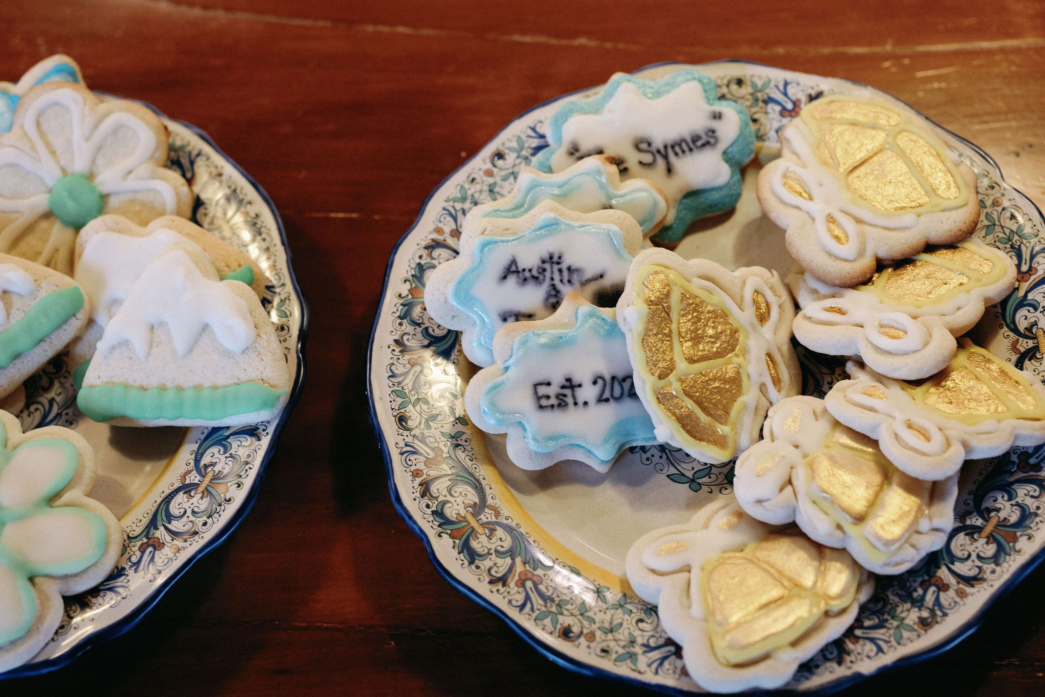 personalized cookies sit on plates as wedding snacks