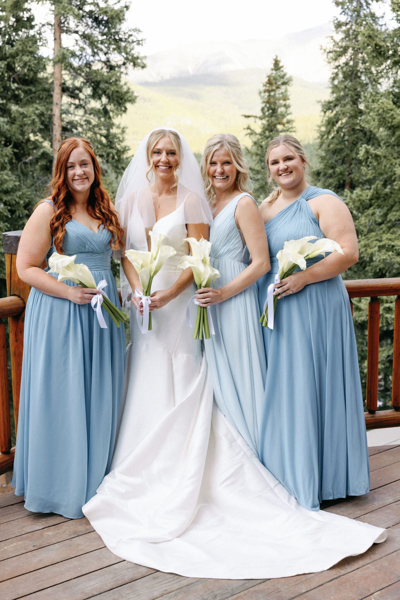 bride smiles during portraits with her bridesmaids