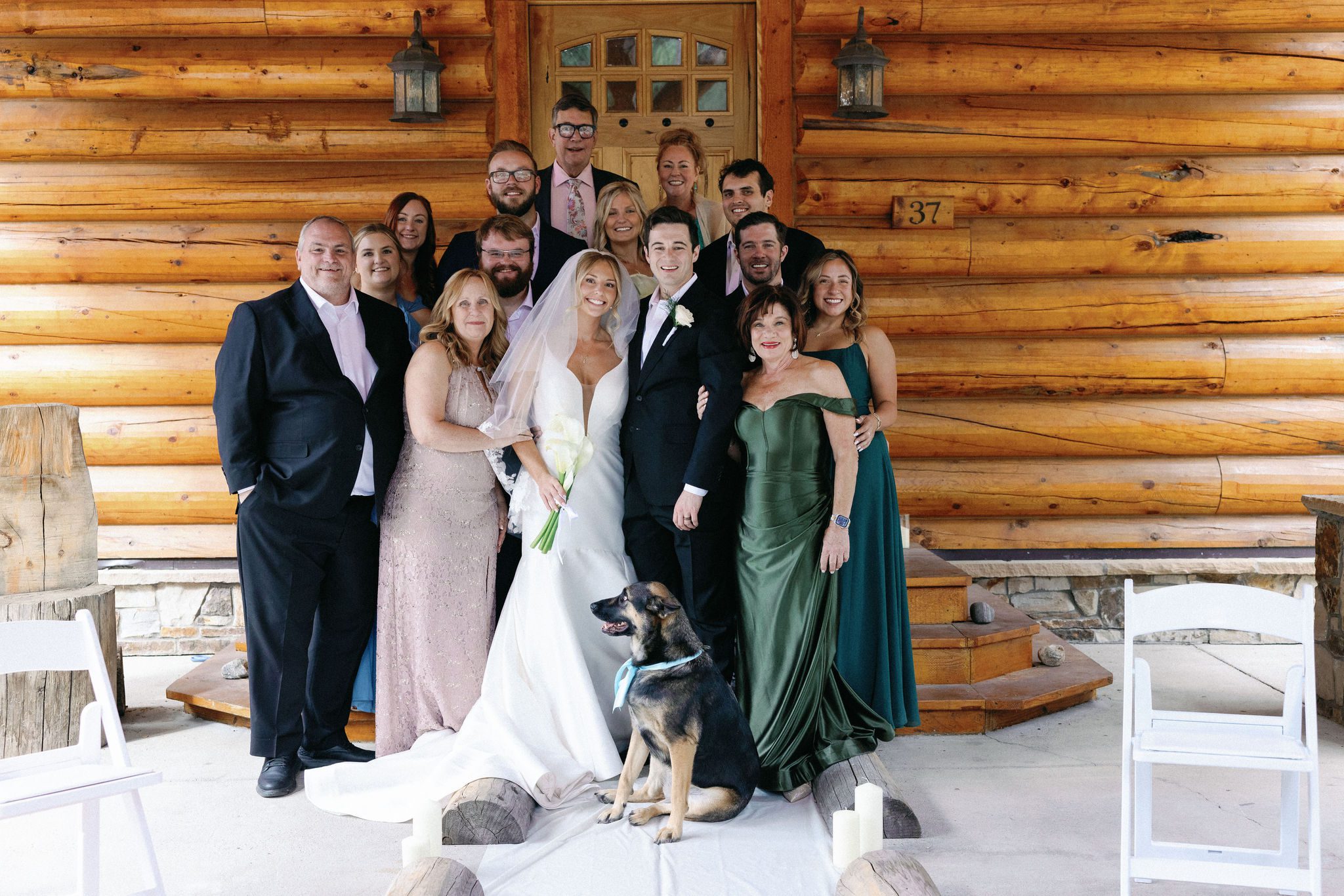 bride and groom stand with their guests and dog during colorado airbnb wedding