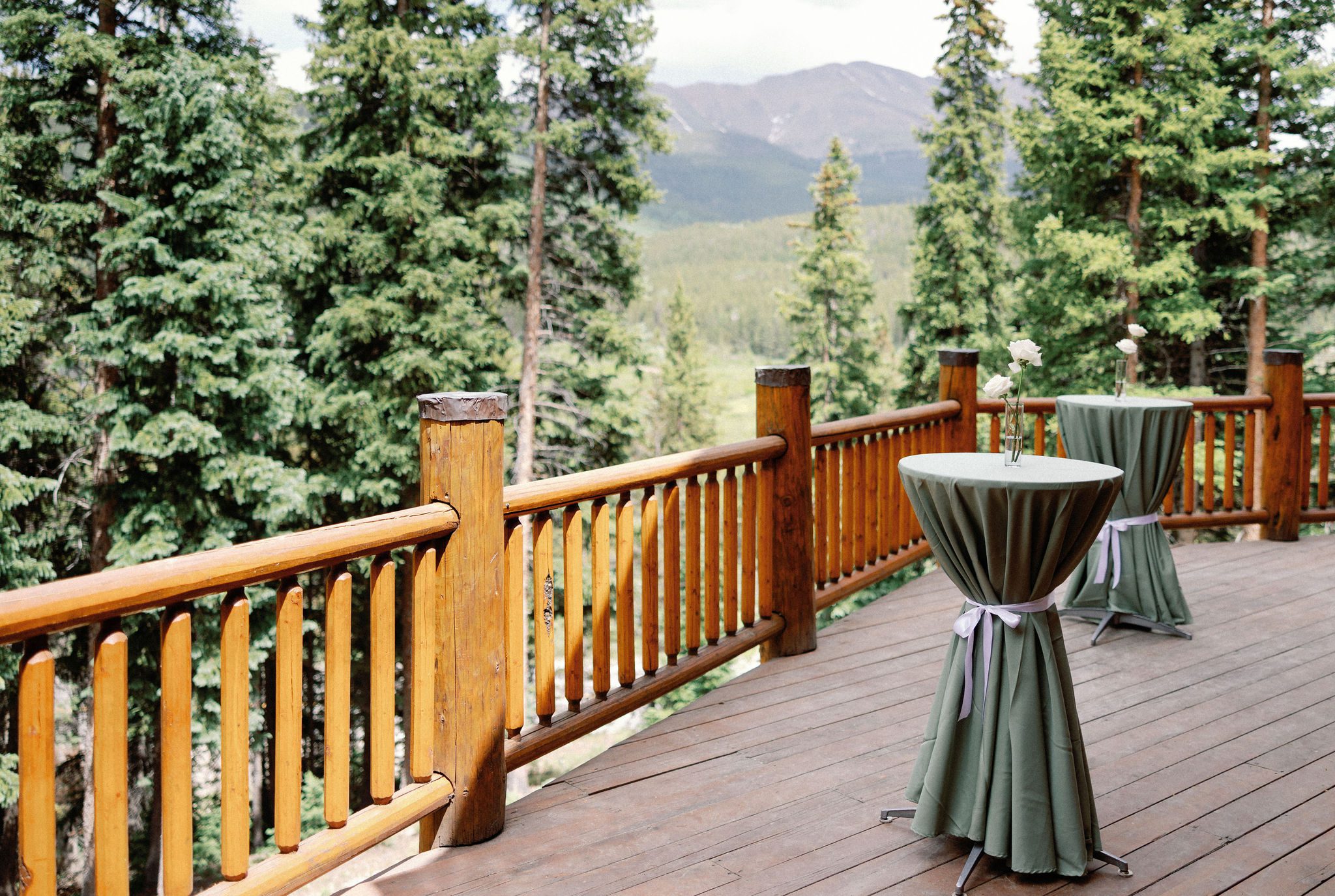 the deck of an airbnb is set up for a wedding reception in colorado