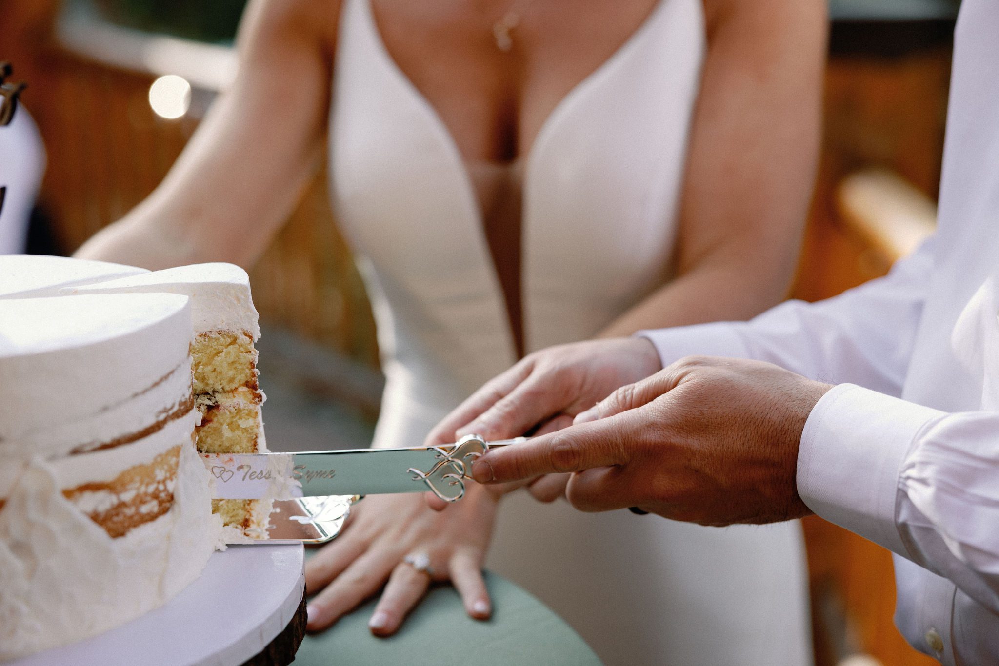 bride and groom cut into wedding cake