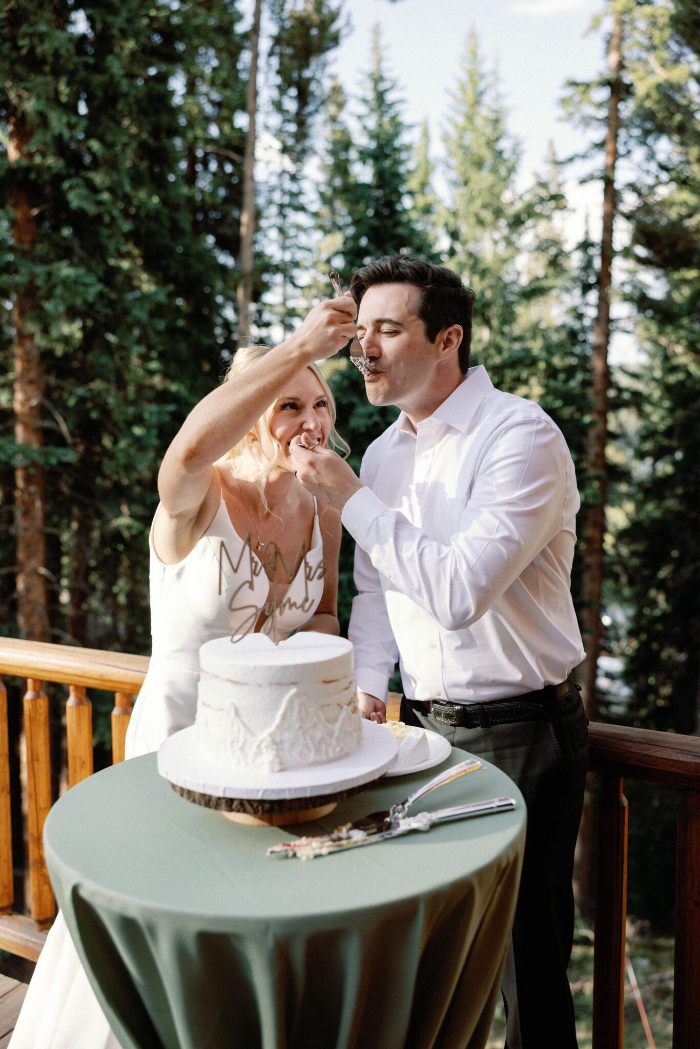 bride and groom feed each other a bite of wedding cake