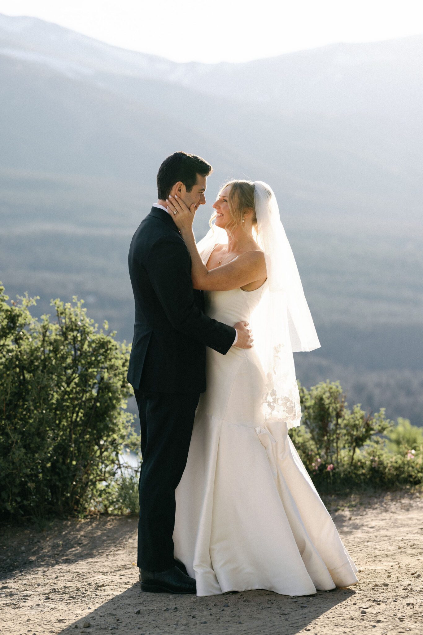 bride and groom embrace with hands around each other during wedding photos at boreas pass