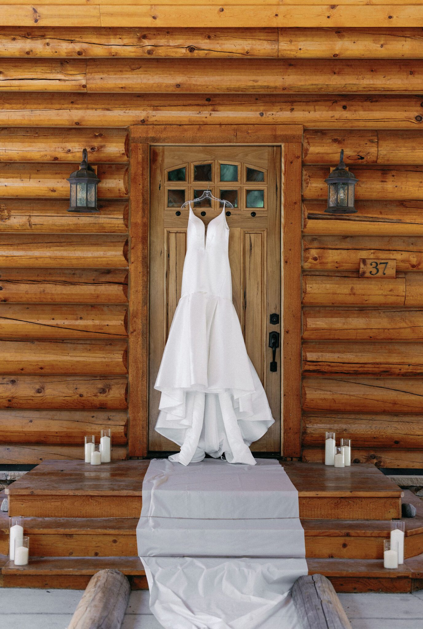 wedding dress hangs from the door of a cabin airbnb in colorado