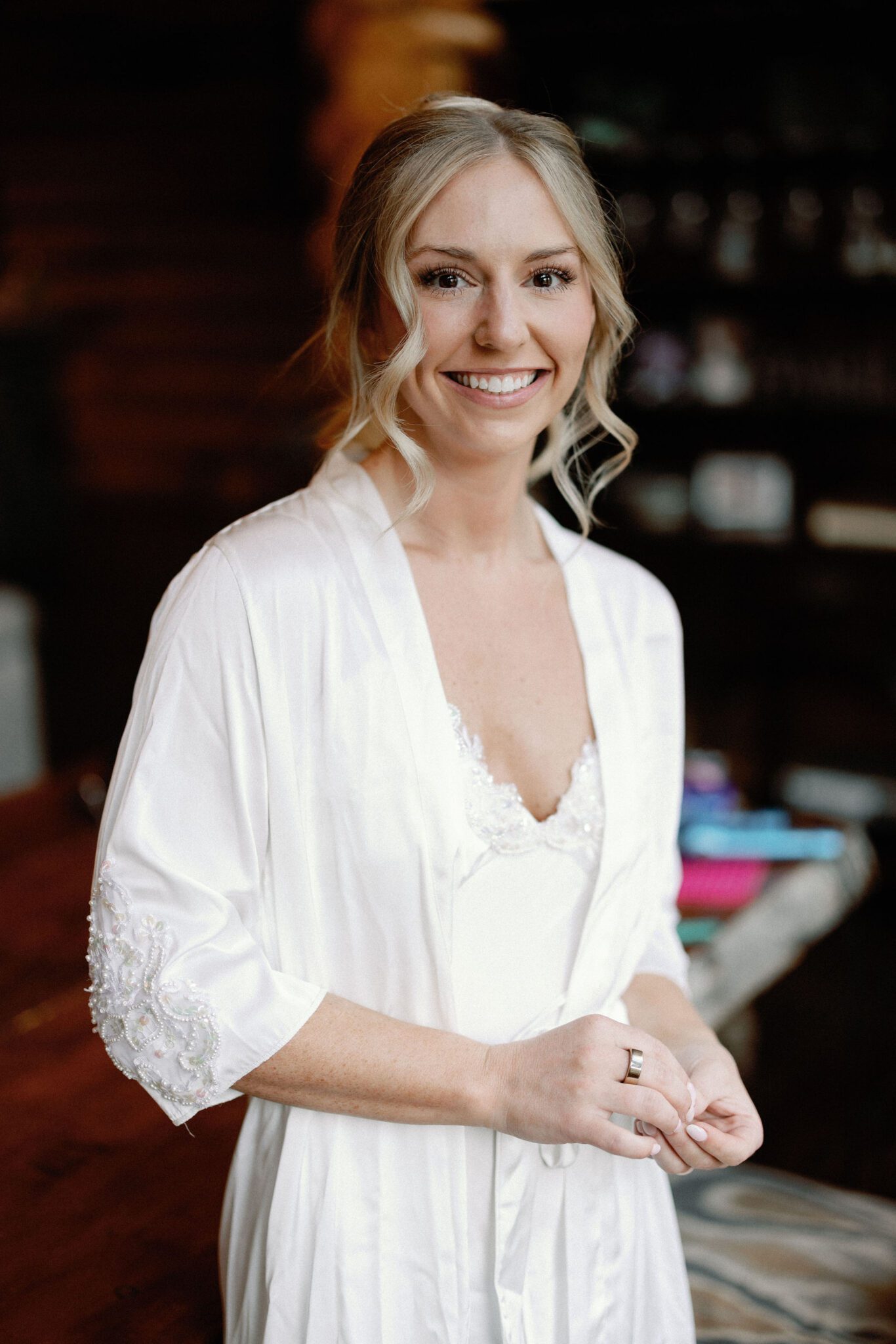 bride smiles at colorado wedding photographer while getting ready