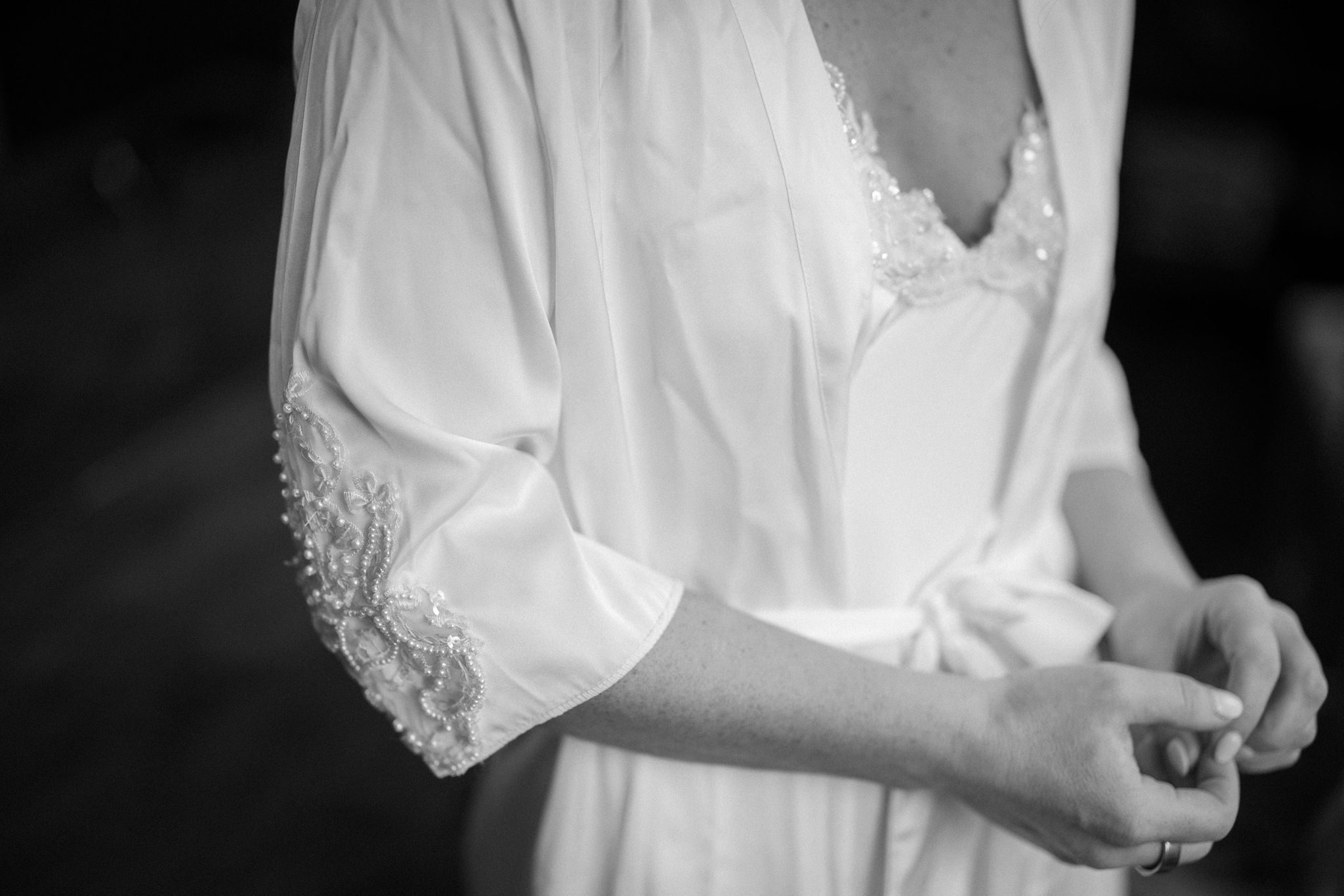 close up photo of brides custom-made bridal robe while getting ready for her wedding