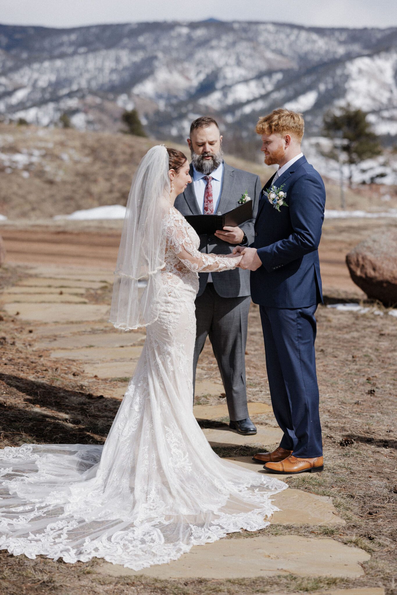 bride and groom stand while saying wedding vows at an airbnb, their colorado elopement location