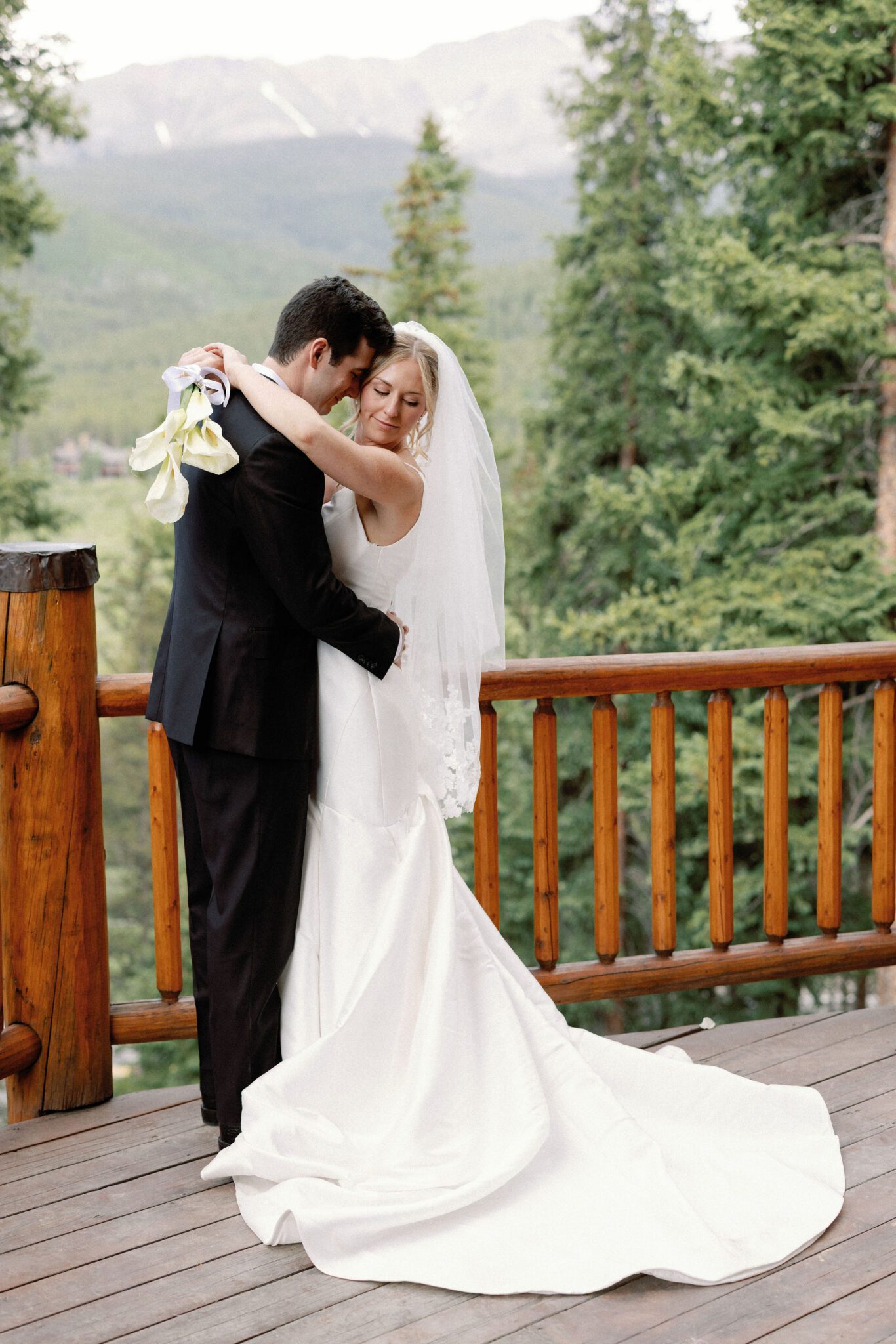 bride and groom pose for wedding photos at their airbnb they used as their elopement location in colorado