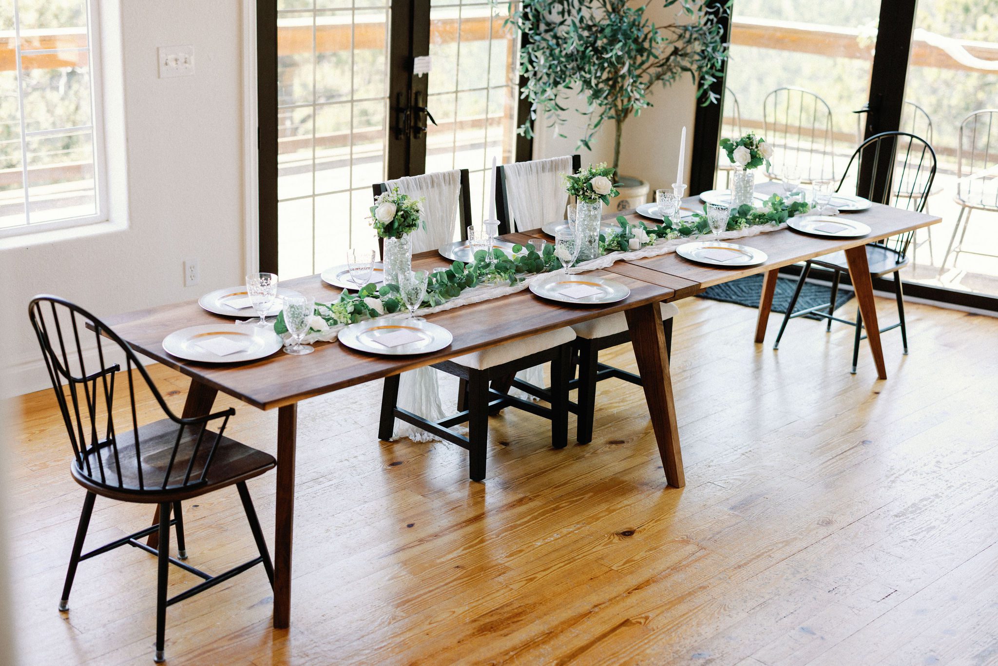table set up with place settings and decor inside the wedding airbnb for reception